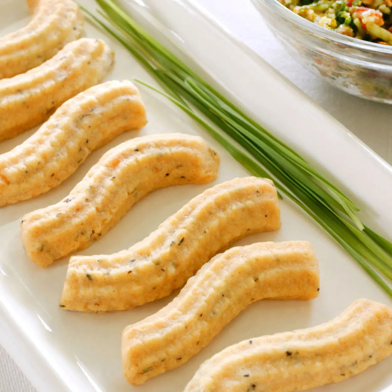 a plate of Asiago cheese straws
