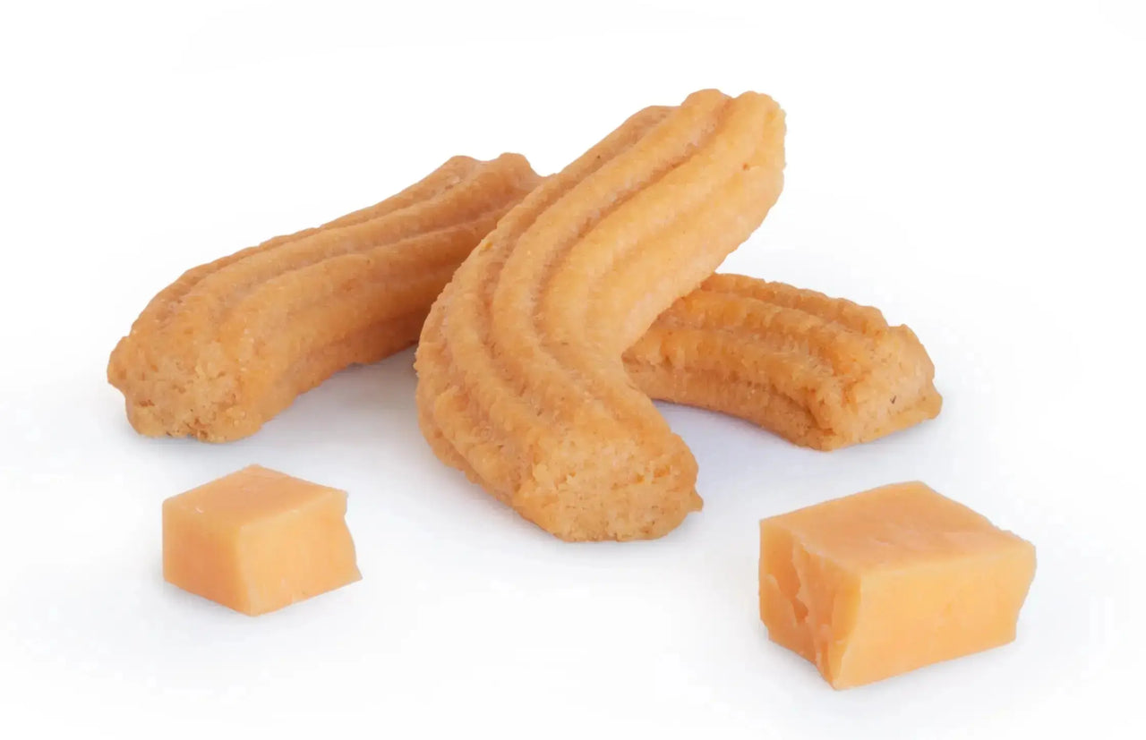 close up image of Janis & Melanie Original Cheese Straws with cubes of cheddar cheese