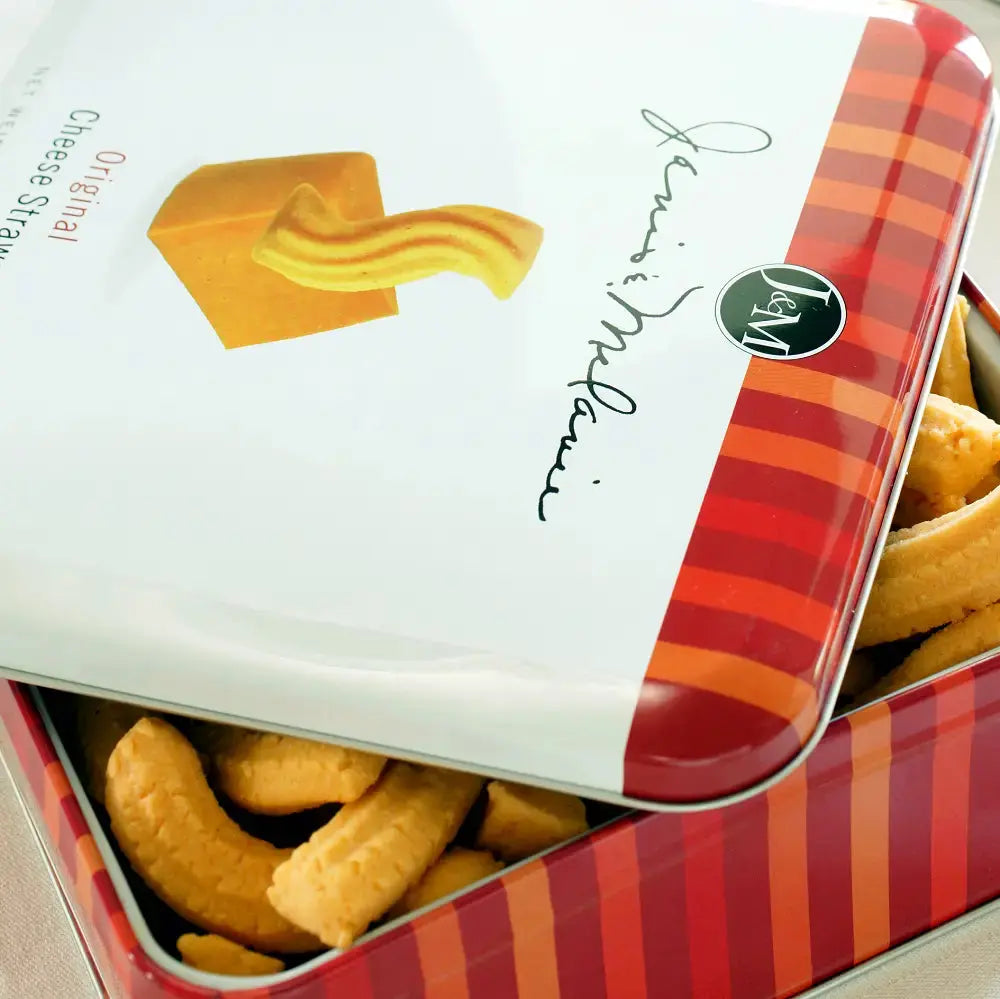 Close up of an open tin of Janis & Melanie Original Cheese Straws