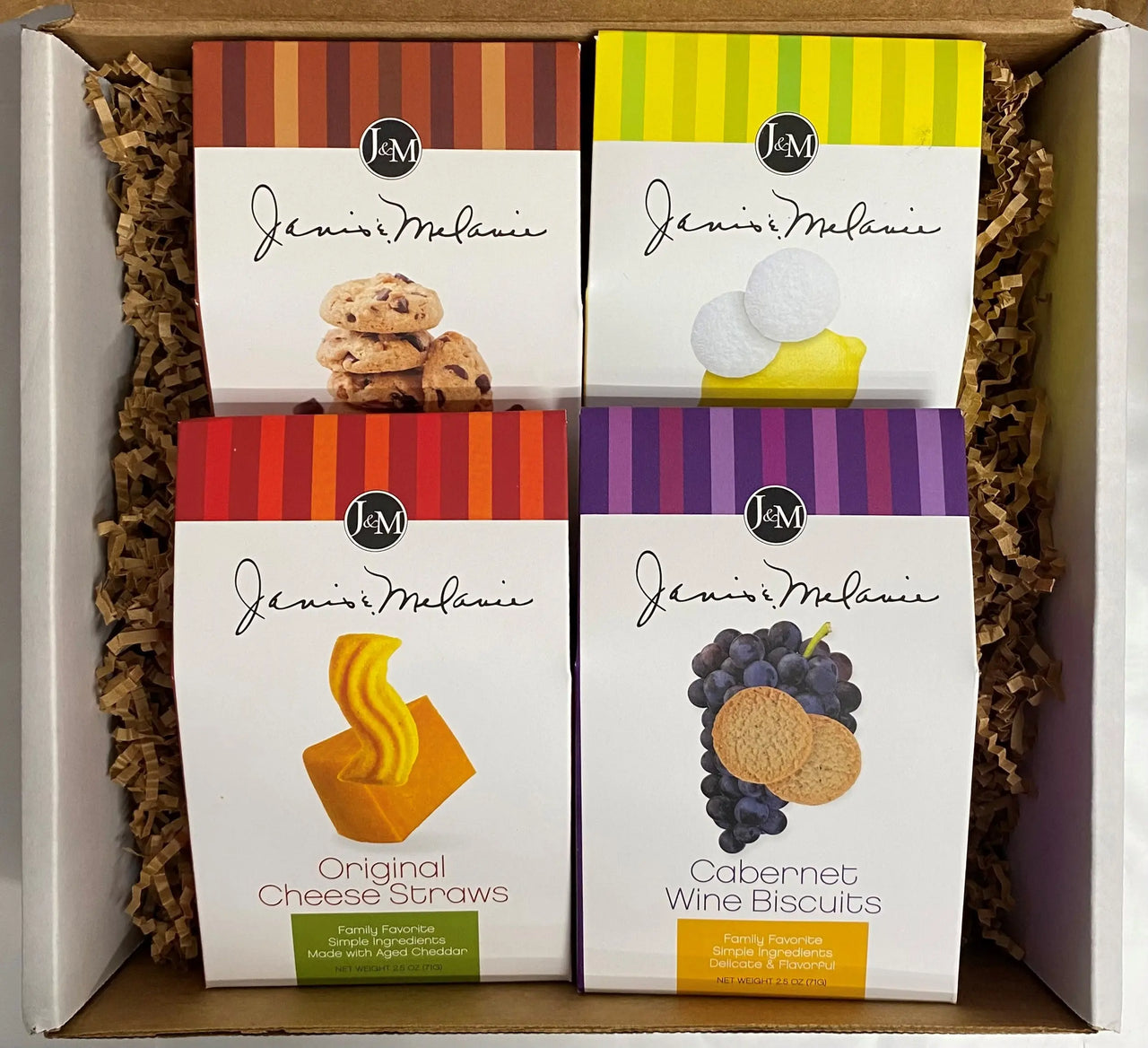A gift box containing four 2.5 oz cartons of assorted cookies and cheese straws with visible packaging for each item.