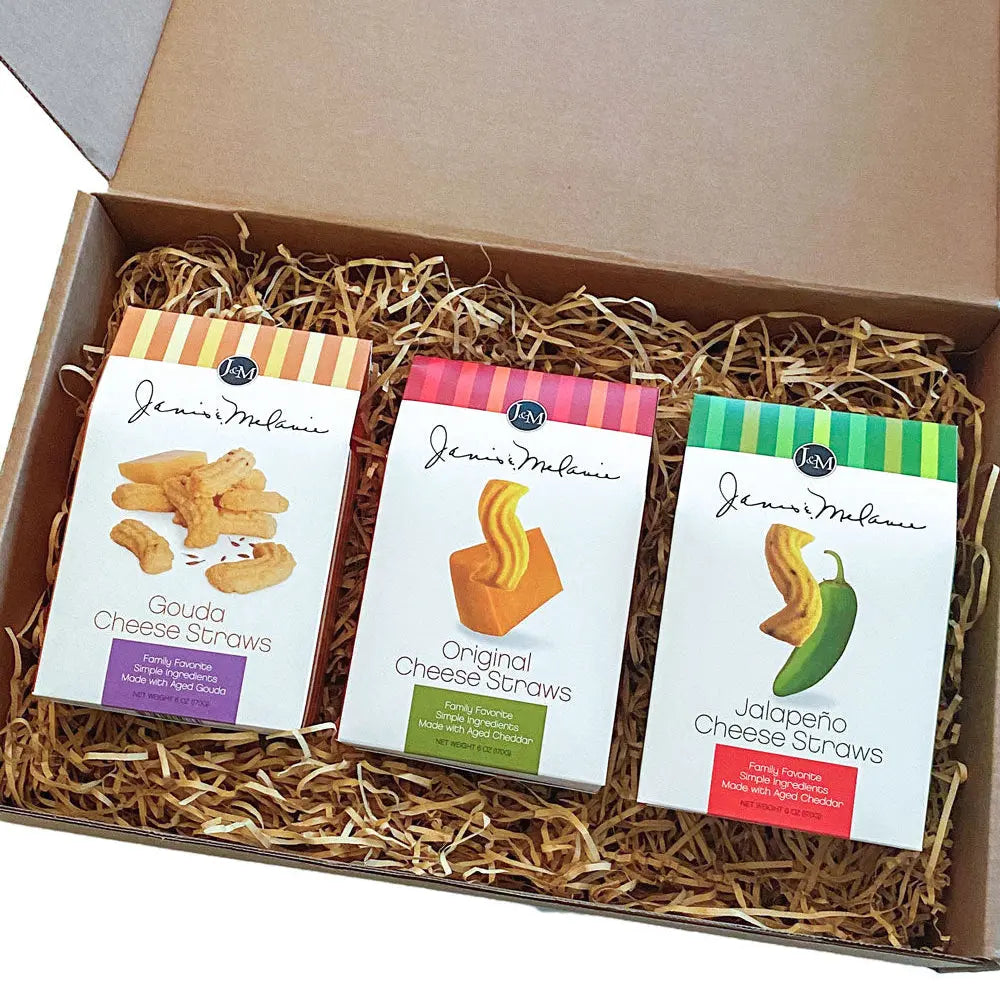 Cheese straws displayed inside an open Janis & Melanie Food = Love gift box
