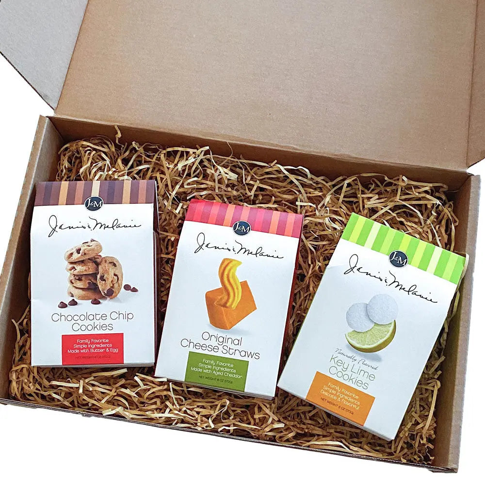 An assortment of favorite Janis & Melanie treats inside an open Food = Love gift box