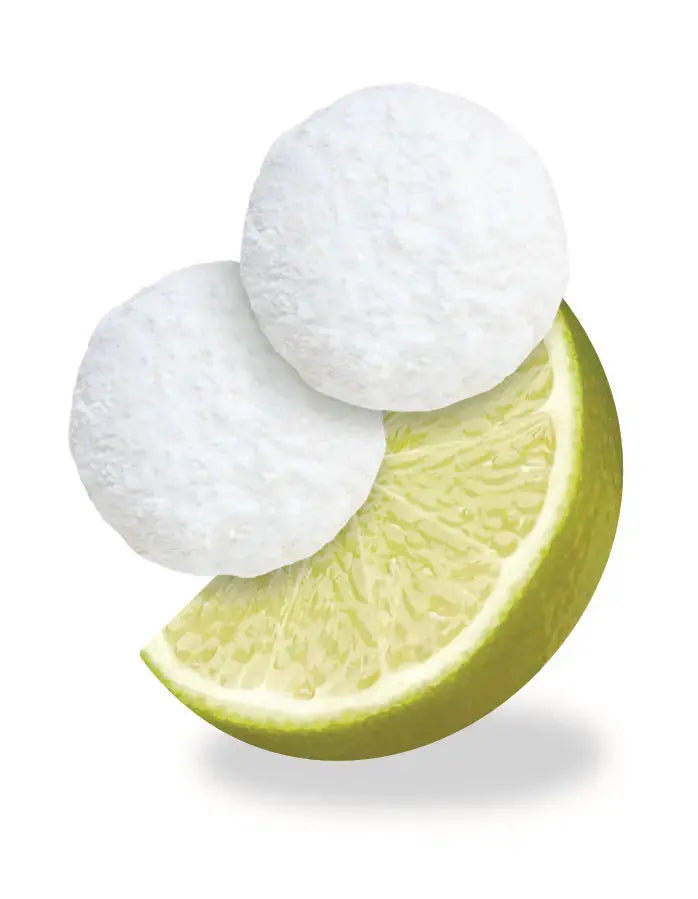 Closeup of two Janis & Melanie Key Lime Tea Cookies and a wedge of lime